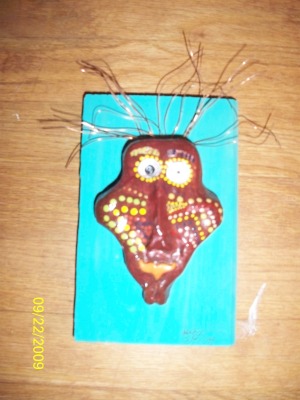 a clay face painted aboriginal markings