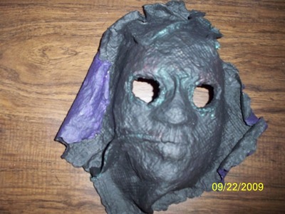 a grey papier mached face