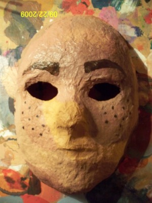 a flesh-colored papier mached face