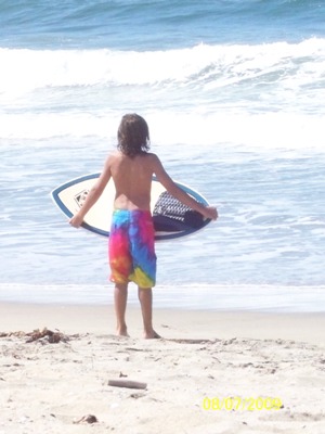 chris with skimboard at bolsa chica